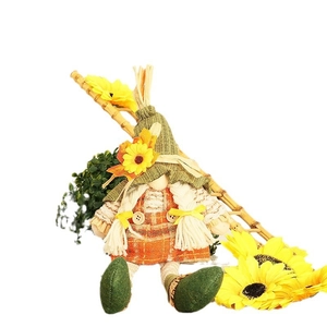 Fall gnome plush with sunflower hat and autumn maple leaf decor on white background