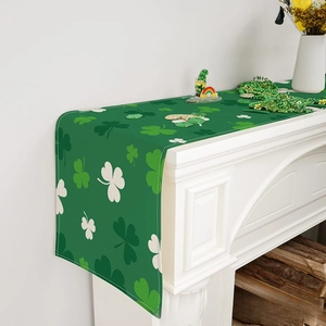 St. Patrick's Day green table runner with clover shamrock pattern on a mantelpiece