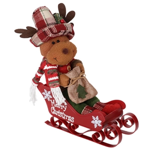 Close-up of reindeer plush with plaid hat on a red metal Merry Christmas sleigh