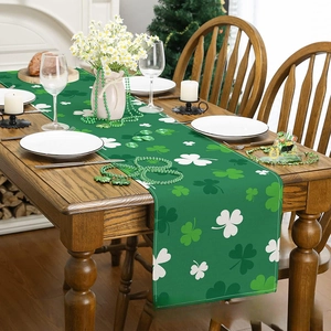 Saint Patrick's Day table runner with green shamrock pattern on wooden dining table