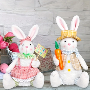Close-up of Easter plush bunny set with sign and carrot on wooden floor background
