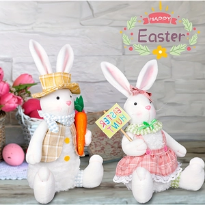 Detail of plush Easter bunnies holding a carrot and an Easter Hunt sign for home decor