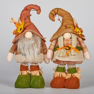 Close-up of Thanksgiving gnomes with maple leaf sunflower decorations and knitted textures