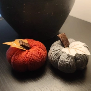 Knitted pumpkin ornaments for autumn harvest festival in red and grey colors