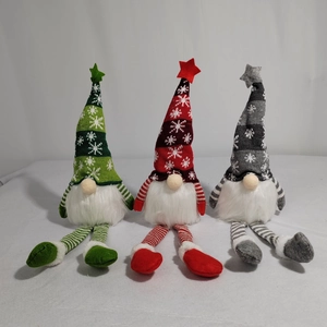 Detailed view of three festive Christmas gnomes with snowflake hats and long striped legs