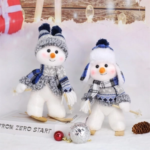 Pair of blue knitted Christmas snowman dolls with wooden skis and poles decoration
