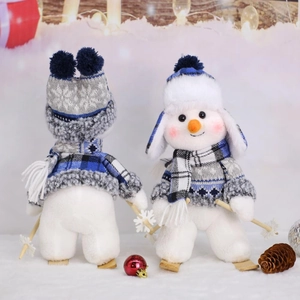Blue fabric skiing snowman figurines with knitted sweaters and wooden skis for holiday decor