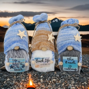 Three beach theme knit ocean gnomes with starfish hats and coastal lifestyle signs