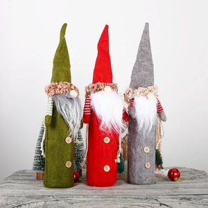 Three Christmas gnome wine bottle covers in red green and grey with faux fur and wood buttons