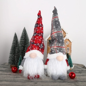 Detail of plush Christmas gnomes with plaid hats and snowy patterns for festive decor
