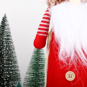 Detailed close-up of a Christmas gnome with a red felt body and a wooden button detail