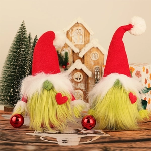Detail of Christmas gnomes with green faux fur bodies and red felt heart accents