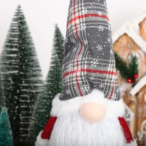 Lighted Christmas gnome plush with plaid hat and white beard in festive decor scene