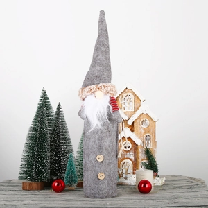 Christmas gnome wine bottle cover with grey felt hat and white beard on festive background