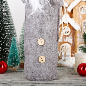 Detail of gray felt gnome wine bottle cover with wooden buttons and long white beard decor