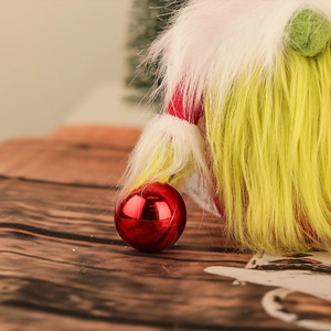 Christmas gnome doll with green beard, red plush hat and festive metal bell ornament