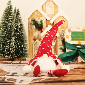 Glow Christmas gnome doll with long legs and white beard on a festive wood background