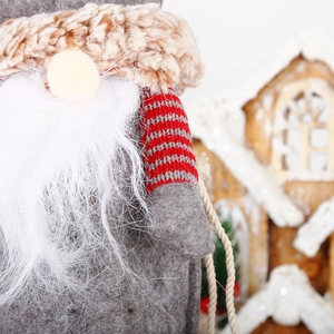 Detailed close-up of a Christmas gnome decoration with a long beard and knitted striped hat