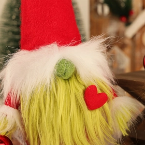 Christmas gnome doll with green beard and red heart cap in a festive holiday setting
