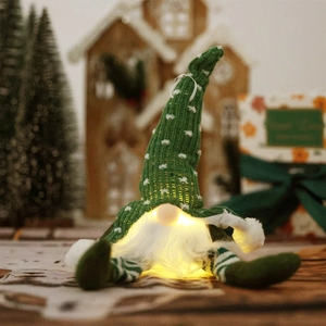 Lighted green Christmas gnome doll with glowing warm light and striped hanging legs
