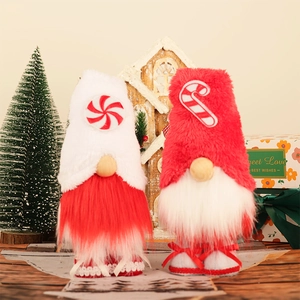 Set of two decorative Christmas gnomes in red and white with festive candy patterns