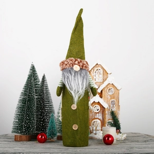 Close-up of green gnome wine bottle cover with long white beard and wooden buttons