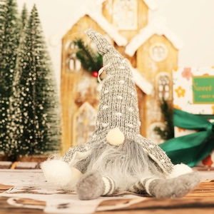 Illuminated Christmas gnome plush with gray knit hat and long beard on festive background
