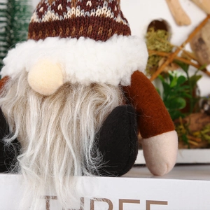 Close-up of a Christmas gnome ornament with a brown knitted hat and grey beard
