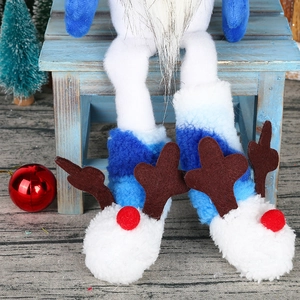 Detail of Christmas gnome plush legs with reindeer antler boots and festive decor