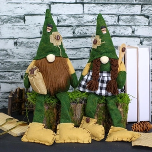 Detail of coffee gnome pair with green hats and hanging legs on rustic wood log