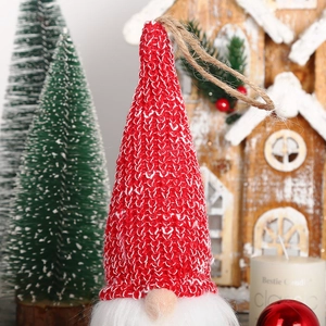 Detail of a Christmas gnome hanging ornament with red knitted hat and plush white beard