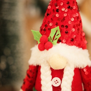 Christmas gnome plush with red sequin hat, white beard and festive berry decorations