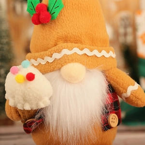 Gros plan d'un gnome de Noël en pain d'épice avec bonnet orange et barbe en peluche