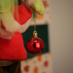 Leuchtende gesichtslose Zwergpuppe mit roter Weihnachtskugel für festliche Innendekoration