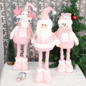 Pink and white Christmas figurines set including Santa, snowman, and reindeer ornaments