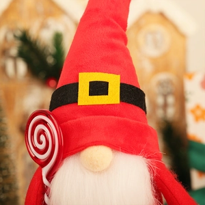 Christmas gnome doll with red hat and candy cane decoration for holiday desktop display