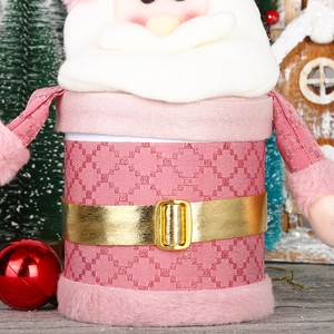 Detail of pink plush Santa candy box with golden buckle and quilted texture ornament