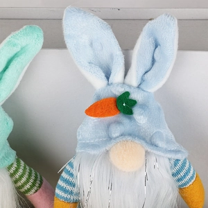 Close-up of Easter gnome with light blue bunny ear hat and carrot felt detail