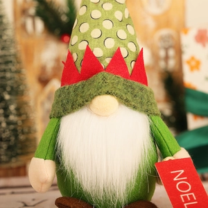 Close-up of Christmas gnome plush with polka dot hat and red NOEL card detail