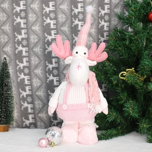 Detail of pink plush Christmas reindeer doll with sequin scarf and knitted overalls decoration