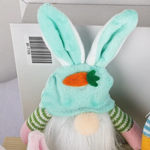 Detailed macro view of Easter faceless gnome with mint green rabbit ear hat and orange carrot