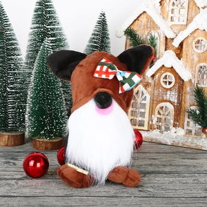 Rudolph Christmas gnome plush toy with reindeer ears and white beard on wooden background