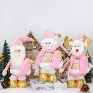 Detailed close-up of pink and gold Christmas plush figures including Santa and reindeer