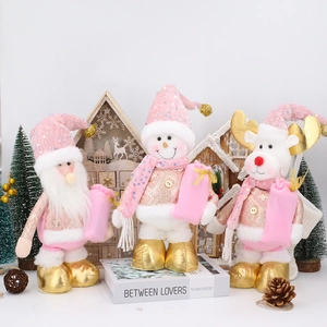 Pink and gold Christmas plush figurines set with Santa, snowman and reindeer on a table