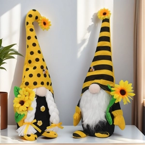 Detailed close-up of sunflower and bee-themed gnomes with knit hats and felt decorations