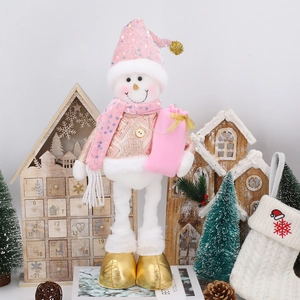Detail of pink and gold Christmas snowman doll with sequins and a gift bag