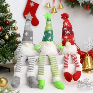 Detailed view of three festive Christmas gnomes with snowflake hats and striped legs
