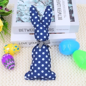 Detailed view of blue polka dot Easter bunny plush with a black and white checkered bow