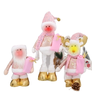 Pink and gold Christmas plush set with Santa, Snowman, and Reindeer figurines