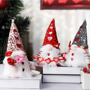 Three sequined Valentine Gnomes with plush hearts and roses for festive home decoration